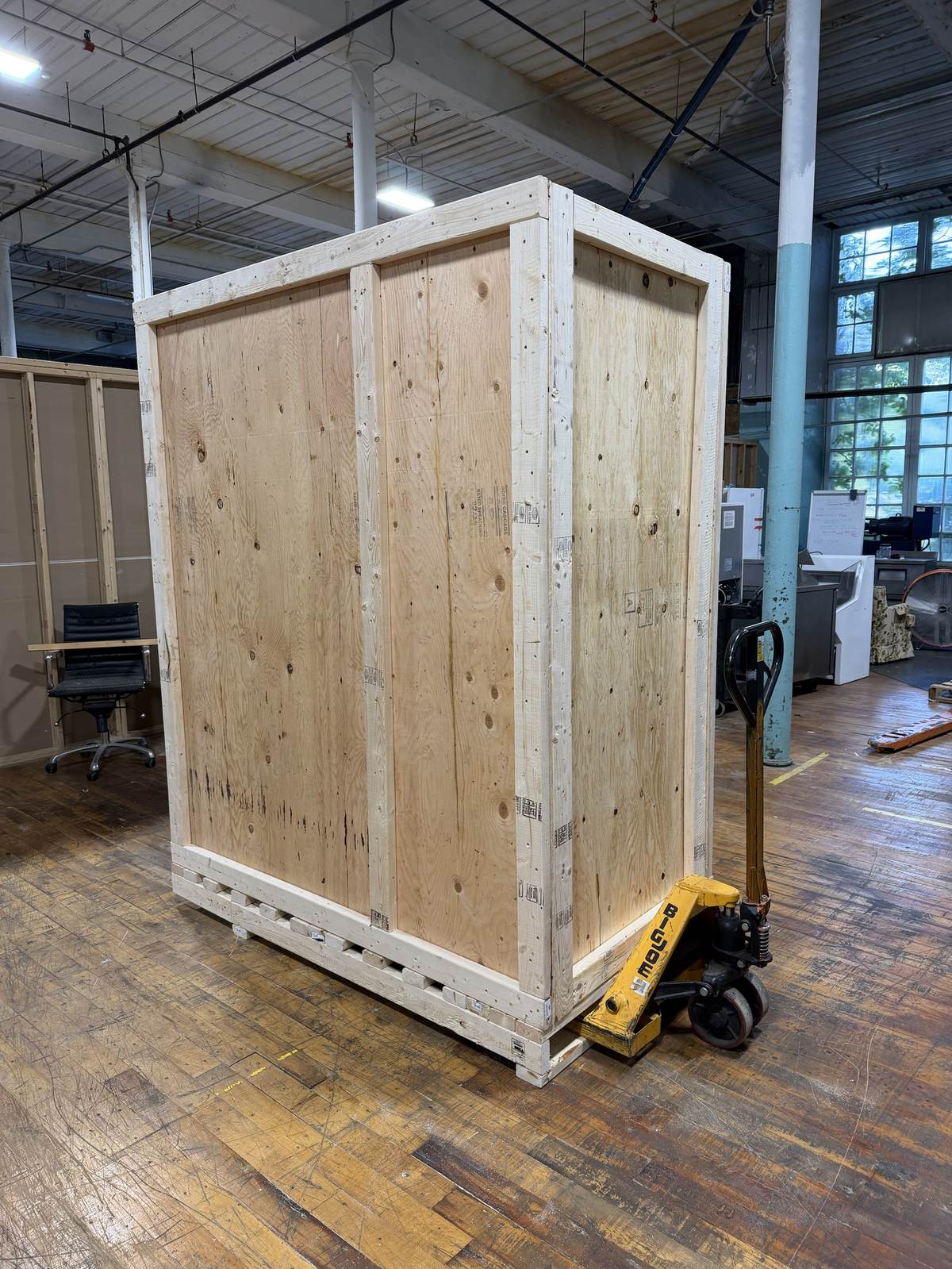 A large wood crate staged near a loading area.