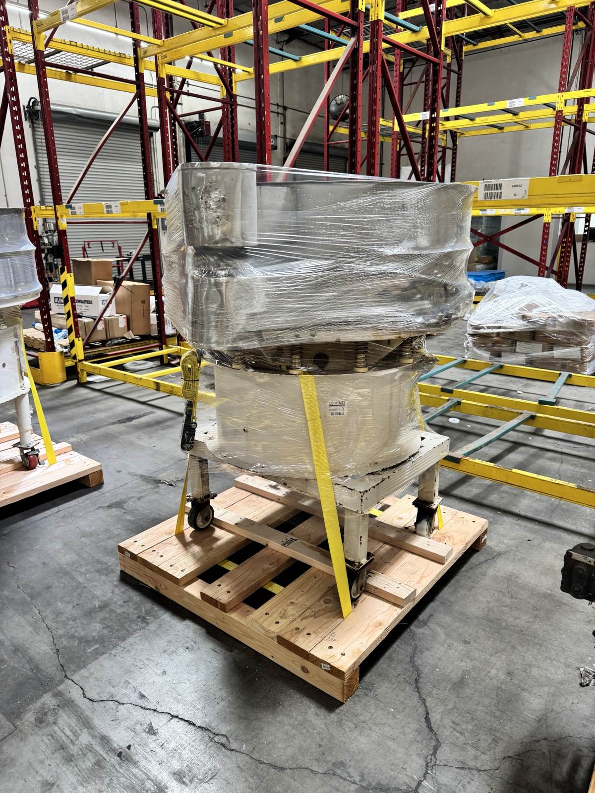 A vibratory screener piece of equipment, wrapped for shipment.