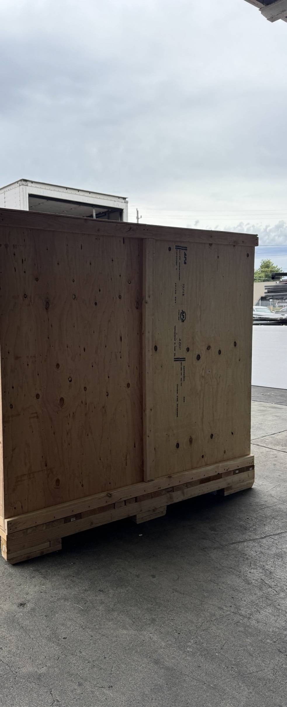 A finished custom wood shipping crate outside SouthCoast Specialty Shipping's shop, ready to load.