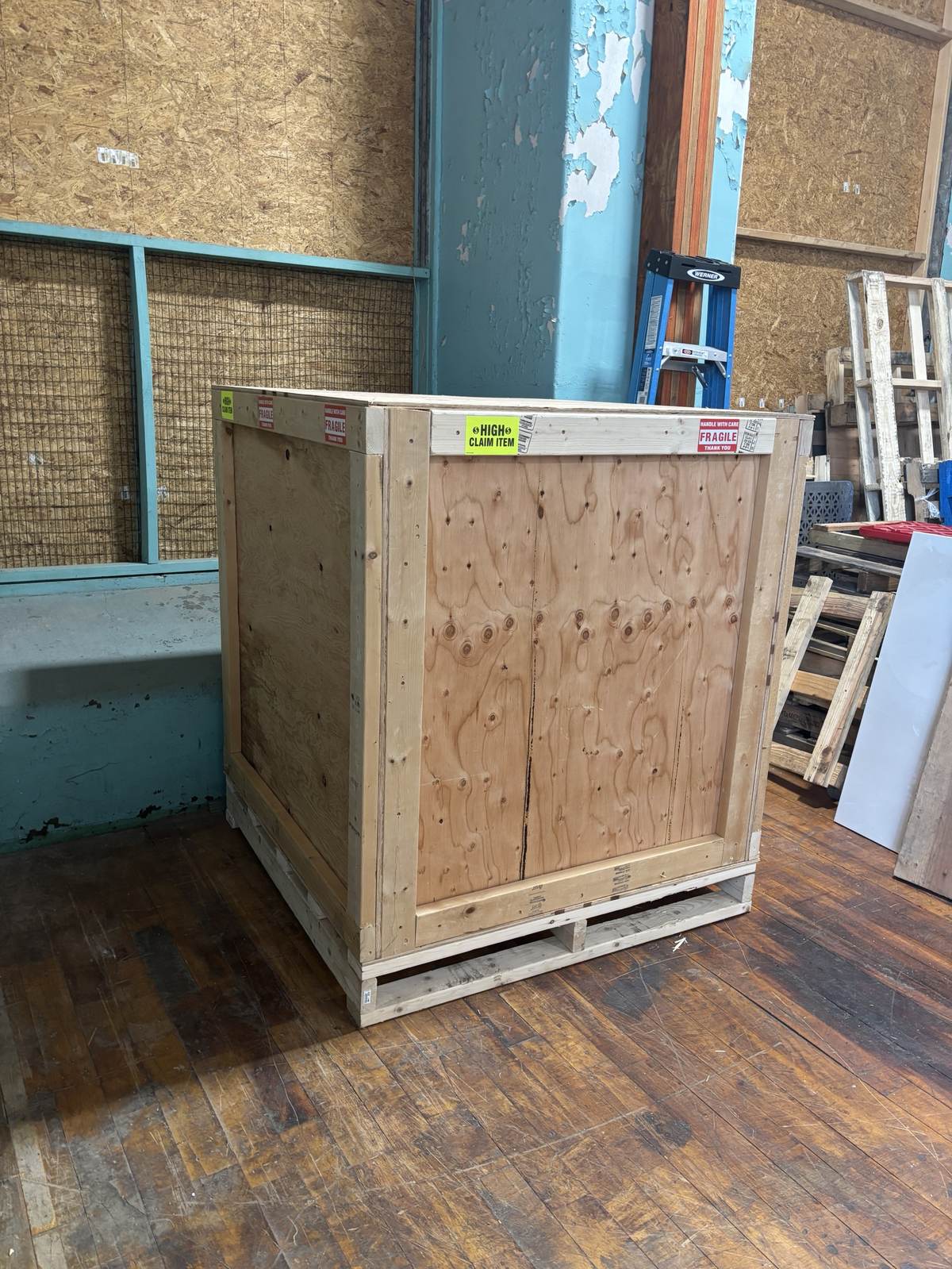 A custom wood crate marked with its dimensions and weight, built to spec.